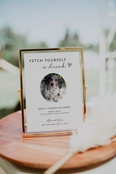 a card with a photo of a dog on it sitting on top of a wooden table