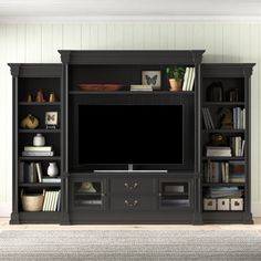 an entertainment center with bookshelves and a flat screen tv