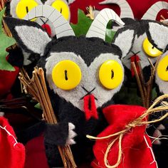 some very cute looking stuffed animals with big yellow eyes