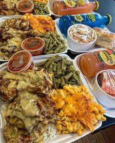 several trays filled with different types of food and condiments on the table