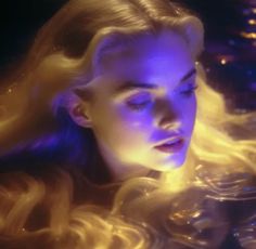 a woman with long blonde hair is looking down at something in the distance while she's surrounded by blue and yellow lights