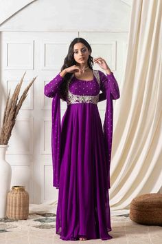 Embody a stylish interpretation of ethnic glamour and contemporary style with this Purple georgette Anarkali Suit. Embroidered with strikingly intricate and plush detailing, this floor-length outfit has a beautiful silhouette to amplify your appeal. It comes with a Dupatta so that you can be ready to strike a pose on intimate celebrations or events.Style Anarkali dress Plush purple Light and breezy Golden detailing Full sleeves Embroidered dupatta Georgette fabric Specifications Model height - 5 Georgette Anarkali Suits, Eastern Dresses, Georgette Anarkali, Designing Ideas, Beautiful Silhouette, Embroidered Dupatta, Purple Light, Anarkali Suit, Anarkali Dress