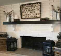 a white brick fireplace in a living room filled with boxes and vases on top of it