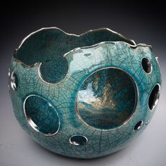 a blue bowl with holes in the middle