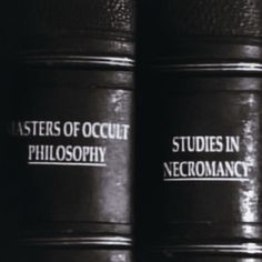 two black books with white lettering on them