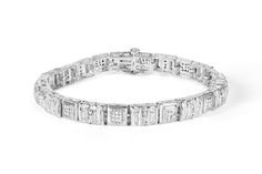 Round and baguette cut diamonds shimmer against a white gold finish on this exquisite two-carat diamond bracelet. Each square link comes together, creating a unique geometric design sure to dazzle her. Modern Diamond Bracelet With Baguette Cut Accents, Formal Diamond Bracelet With Baguette Diamonds, Classic Silver Baguette Diamond Bracelet, Modern Baguette Cut Diamond Bracelet With Accents, Elegant Rectangular Tennis Bracelet With Baguette Diamonds, Modern Baguette Cut Diamond Bracelet For Anniversary, Silver Diamond Bracelet With Baguette Diamonds, Modern Silver Diamond Bracelet With Baguette Diamonds, Rectangular White Gold Diamond Bracelet