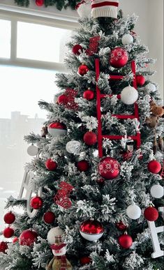 a decorated christmas tree with red and white ornaments