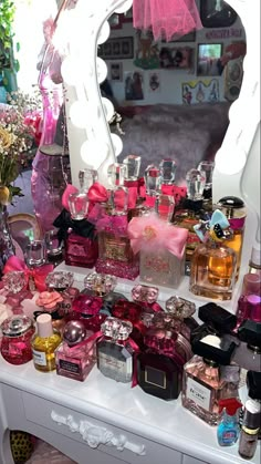 a vanity with lots of perfume bottles on it