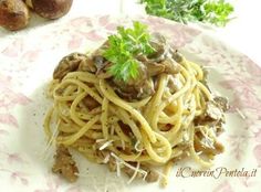 pasta with mushrooms and parmesan cheese on a pink floral plate next to bread