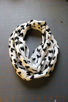 a black and white cow print scarf laying on top of a table