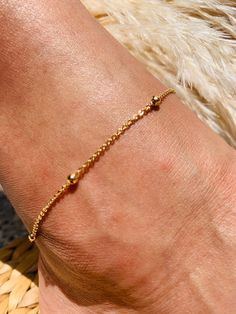 "18 Karat Gold Filled Ball Chain Anklet Anklet length: 10\" Material: 18 Karat Gold Filled, Hypoallergenic. Tarnish Resistant. Gold-filled does not de-laminate or peel like Gold plated Jewelry nor does it tarnish as readily as silver. Generally speaking, gold filled is better quality and will have a much longer lasting color than plated jewelry. We recommend keeping abrasive chemicals away from the jewelry for the items to last. Thank you for visiting and supporting our small business! We hope y Minimalist Anklet With Satellite Chain As Gift, Minimalist Satellite Chain Anklet As Gift, Adjustable Satellite Chain Anklet As Gift, Simple Gold Anklet, Dainty Gold Hypoallergenic Anklets, Adjustable Minimalist Gold Anklet, Anklets Simple, Yellow Gold Delicate Chain Anklet, Gold-plated Adjustable Anklets