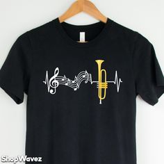 Trumpet Shirt for Musician - Our shirt options feel soft and comfortable made from cotton (heather colors also contain polyester).  - Soft t-shirts with quality shirt print - Fast customer service - We are here to help answer any questions! - Many different color and size options SIZING INFO Our unisex tees have a regular t-shirt fit. Width and length measurements for all sizes can be seen in the size chart images. If you prefer a looser fit we suggest 1 size up. Product measurements may vary up Fitted Cotton Music-themed T-shirt, Music-themed Fitted Cotton T-shirt, Trumpet Shirts, Trumpet Gifts, Marching Band Shirts, Trumpet Instrument, Band Shirt, Band Shirts, Marching Band