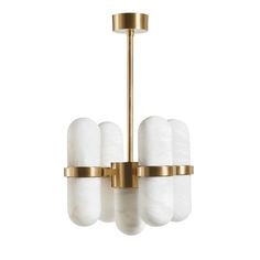 a brass chandelier with white glass shades