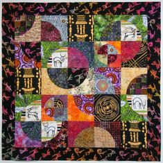 a quilt with many different designs on it