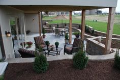 an outdoor patio with chairs, tables and umbrellas