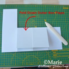 the folded paper is being cut into squares