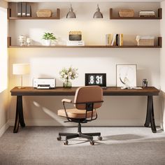 a desk with a chair and shelf above it in an office space that has carpeted flooring