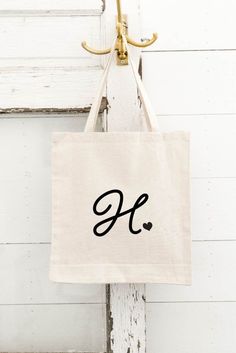 "Our CUSTOM Monogram Tote Bags make the perfect GIFT for your Besties! Hold everything you need for a day at the beach or shopping trip. Don't forget your hair ties, can coolers, T-shirts, and tattoos. DETAILS: This listing is for 1 Personalized Tote Bag with your Initial Monogram. PLEASE leave your initial for bags in the box provided. Size of Bag: 14.5\"W x 16\"H 100% Cotton - LIGHTWEIGHT Canvas Bag - 6 oz. We have Natural, Navy, Black. Vinyl Colors: White, Black, Gold, Rose Gold IN A RUSH, PL Chic Monogram Canvas Tote Box Bag, Personalized Monogram Tote Bag, Monogram Print Tote Bag, Formal Monogram Canvas Tote Bag, Personalized Letter Print Rectangular Bag, Personalized Rectangular Bag With Letter Print, Rectangular Monogram Canvas Bag For On-the-go, Elegant Pre-owned Monogram Canvas Bag, Sarcastic Clothing