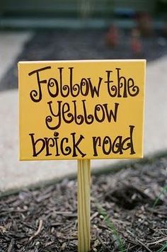 a yellow sign that says follow the yellow brick road