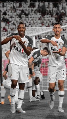 the soccer players are warming up before their match against each other in black and white