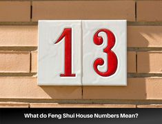 a house number sign on the side of a brick building that says, what do fong shu house numbers mean?