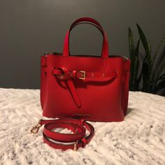 This Is A Brand New Gorgeous Dark Red Sangria Small Satchel With 3 Compartments. Plenty Of Room For Your Items. 10.75"W X 7.75"H X 4.5"D Pebble Leather Gold Toned Hardware And Logo Adjustable/Removable Shoulder Strap Magnetic Tab Closure Zipper Closure Interior Center Pocket 1 Interior Zipper Closure Wall Pocket 1 Interior Slip Wall Pocket Red Rectangular Satchel With Branded Hardware, Red Satchel With Top Handle And Branded Hardware, Red Leather Satchel With Branded Hardware, Luxury Red Satchel With Gold-tone Hardware, Red Rectangular Satchel With Silver-tone Hardware, Red Leather Bag With Branded Hardware, Designer Red Satchel With Gold-tone Hardware, Red Leather Bag With Gold-tone Hardware, Designer Red Bags With Silver-tone Hardware