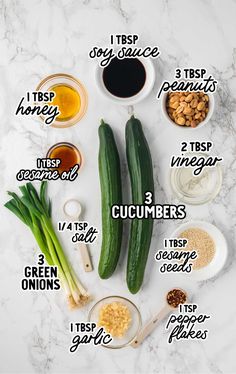 the ingredients for cucumbers on a marble counter top