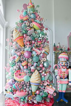 a brightly colored christmas tree with lots of candy and candies on it's top