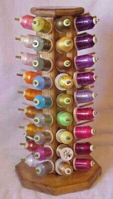 a wooden rack filled with lots of spools of thread