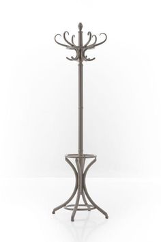 a metal coat rack with three hooks on it