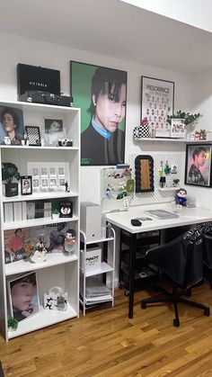 an office with white shelves and pictures on the wall