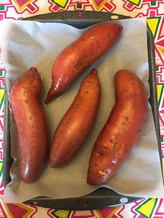 three hot dogs are sitting in a tray