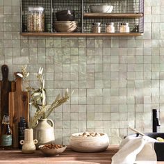 the kitchen counter is covered with dishes and utensils