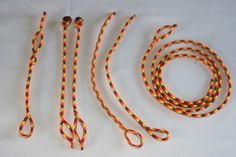 three different colored ropes on a white surface