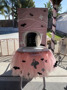 a costume made to look like a microwave oven with bats on it and pink tutu