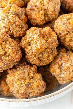 a bowl filled with meatballs sitting on top of a table