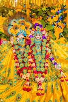 an elaborately decorated statue in front of flowers