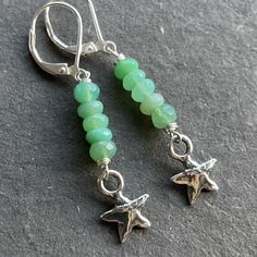 Bright beautiful faceted chrysoprase wired in sterling silver show off a sweet solid sterling silver artisan star. The approximate length is 1 7/8". The leverbacks shown are an upgrade. Please choose your earwire preference. Your jewelry will arrive beautifully giftboxed. Nickel-free Silver Chrysoprase Jewelry, Handmade Green Star-shaped Jewelry, Green Star-shaped Handmade Jewelry, Nickel-free Chrysoprase Jewelry Gift, Adjustable Silver Jewelry With Chrysoprase, Adjustable Silver Chrysoprase Jewelry, Pebble Jewelry, Hardware Jewelry, Silver Turquoise Earrings