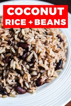 a white plate topped with rice and beans next to a red sign that says coconut rice and beans