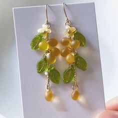 These handmade earrings are crafted with Czech glass grapes, giving them a unique and charming design. The earrings feature a water drop shape, which is both elegant and playful, perfect for adding a touch of sweetness to your look. The earrings are versatile and can be worn for a variety of occasions, from casual outings to special events. The ear clips are comfortable to wear and will securely hold the earrings in place. These earrings are a great gift for anyone who loves handmade jewelry, un Elegant Drop Earrings, Handmade Earrings Design, Grape Jewelry, Glass Grapes, Diy Jewelry Making Tutorials, Plant Earrings, Grape Earrings, Unique Butterfly, Ear Clips