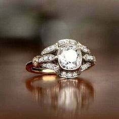 a diamond ring sitting on top of a wooden table