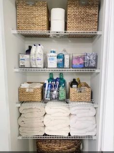 an organized bathroom closet with baskets and toiletries