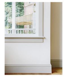 a cat sitting on the floor in front of a window