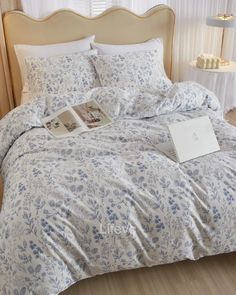 a bed with blue and white flowers on it