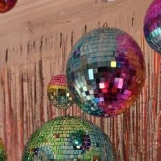 several disco balls are hanging from the ceiling