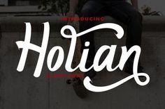 a man sitting on top of a skateboard next to the words hollian