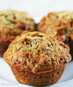 three muffins sitting on top of a white plate