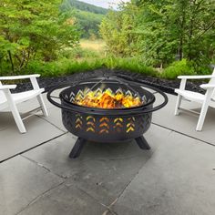 an outdoor fire pit with chairs around it