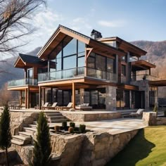 a large house sitting on top of a lush green hillside