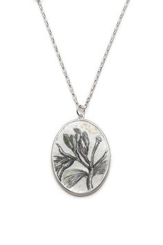 This one of a kind botany inspired, oval hand painted enamel necklace is inspired by a botanical illustration of a jasmin flower. I have adapted an image that I came across in an antique book. The jasmin flower is painted with underglazes on a pre-enamelled fine silver foil and copper base. It is fired in the enamelling kiln to fuse the enamels on the silver surface. The pendant is set in the sterling silver bezel. 24K gold foils are used in the drawing. The under-fired transparent glaze creates a look of a morning dew on the mat surface of the pendant.     As every piece is hand-crafted, your selected artwork may have a slight variation compared to the adjoining photograph. As all our jewelry pieces this pendant also arrives in its beautiful velour box. Nature-inspired Oval Engraved Necklaces, Nature-inspired Oval Engraved Necklace, Oval Silver Necklace With Pressed Flowers, Jasmine Necklace, Botanical Book, Jasmine Plant, Jasmine Flower, Enamel Necklaces, Silver Foil